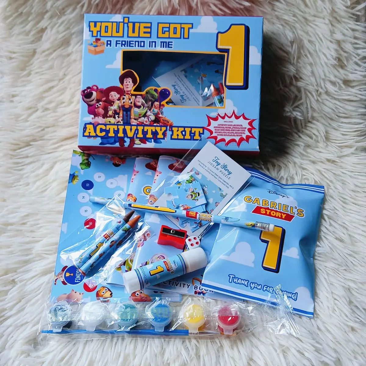 First-birthday themed candy gift packs arranged in a box
